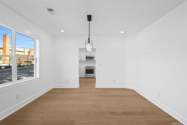 2501 S Maple St, Little Rock, AR 72204 - unfurnished dining area featuring baseboards, light wood-style flooring, and recessed lighting