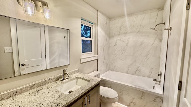 bathroom with toilet, tiled shower / bath, and vanity
