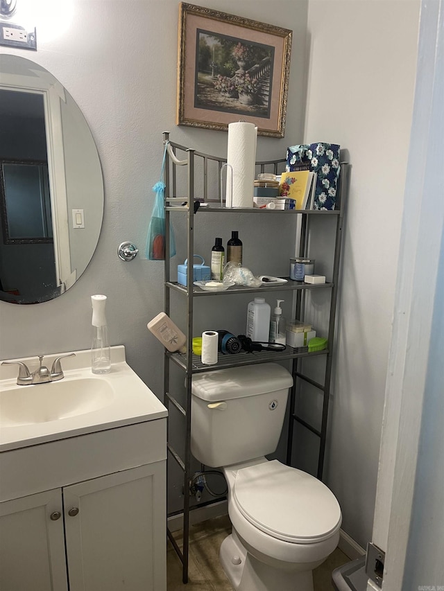 half bathroom featuring toilet and vanity