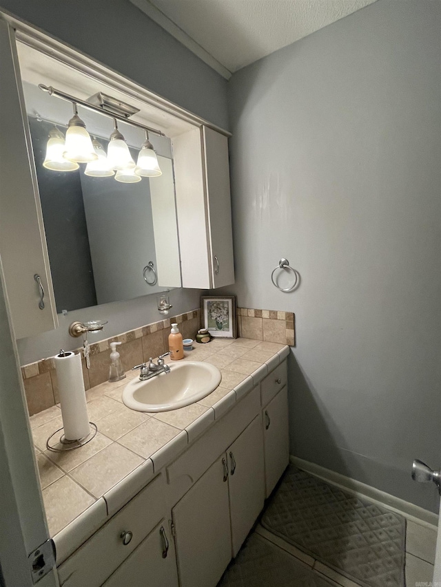 bathroom with vanity, baseboards, and decorative backsplash