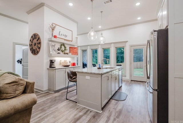 92 Hudson Dr, Sheridan, AR 72150 - kitchen featuring freestanding refrigerator, a sink, light wood finished floors, light stone counters, and recessed lighting