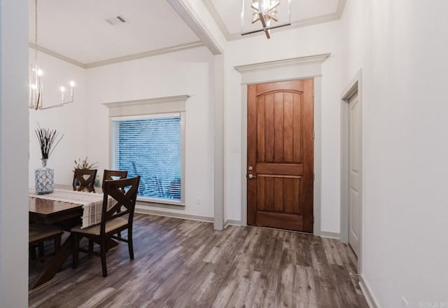 92 Hudson Dr, Sheridan, AR 72150 - foyer entrance featuring a chandelier, wood finished floors, crown molding, and baseboards