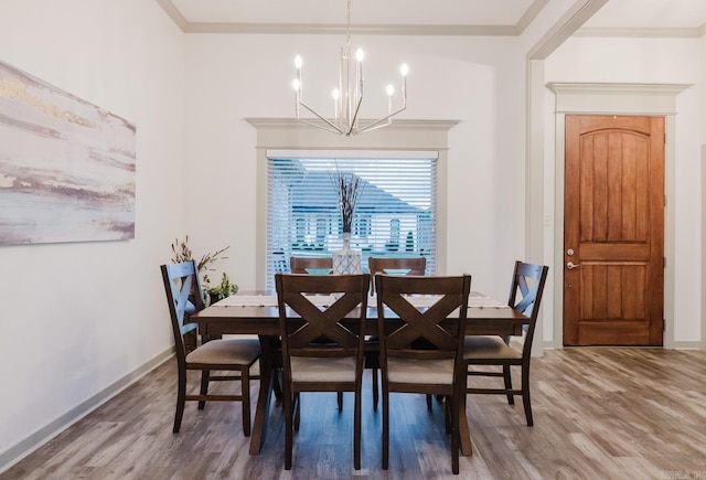 92 Hudson Dr, Sheridan, AR 72150 - dining space featuring a chandelier, wood finished floors, ornamental molding, and baseboards