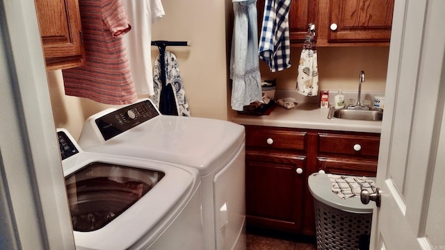 washroom with washer and clothes dryer and cabinet space