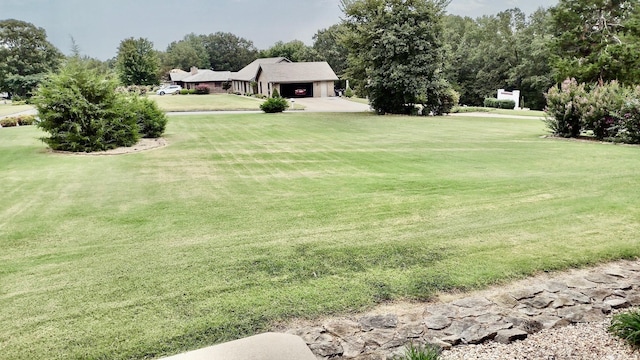 view of grassy yard featuring an attached garage
