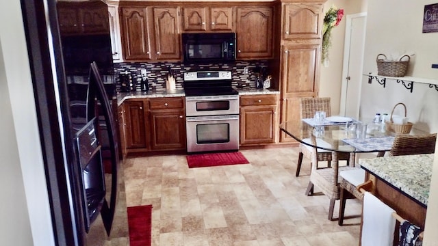 kitchen with black appliances, tasteful backsplash, and brown cabinetry