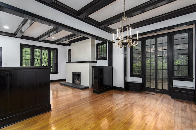 2108 Beechwood, Little Rock, AR 72207 - unfurnished living room with hardwood / wood-style flooring, a chandelier, beamed ceiling, a fireplace with raised hearth, and baseboards