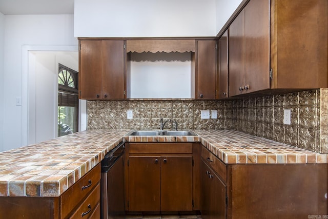 2108 Beechwood, Little Rock, AR 72207 - kitchen featuring dishwashing machine, decorative backsplash, a peninsula, a sink, and tile counters