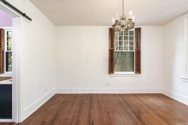 2108 Beechwood, Little Rock, AR 72207 - unfurnished room with a chandelier, dark wood finished floors, baseboards, and a barn door