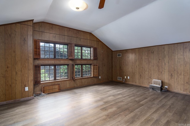 2108 Beechwood, Little Rock, AR 72207 - additional living space with radiator heating unit, wood walls, wood finished floors, vaulted ceiling, and ceiling fan