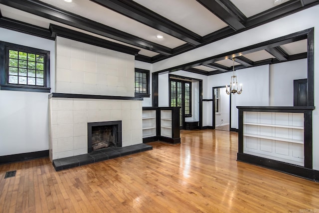 2108 Beechwood, Little Rock, AR 72207 - unfurnished living room with wood-type flooring, baseboards, a chandelier, crown molding, and beam ceiling