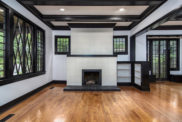 2108 Beechwood, Little Rock, AR 72207 - unfurnished living room featuring crown molding, baseboards, healthy amount of natural light, hardwood / wood-style flooring, and beamed ceiling