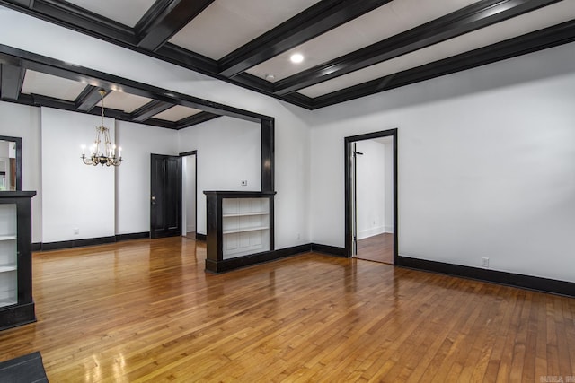 2108 Beechwood, Little Rock, AR 72207 - empty room with a chandelier, beamed ceiling, hardwood / wood-style floors, and baseboards