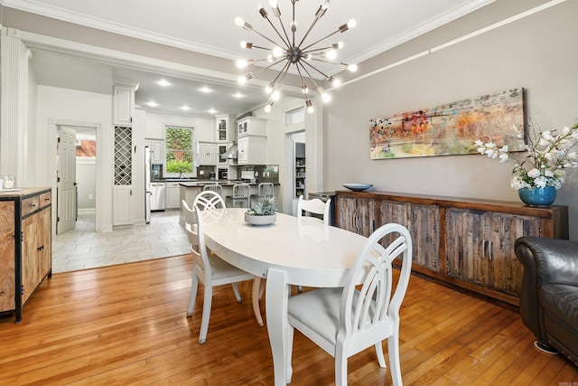 121 N Woodrow St, Little Rock, AR 72205 - dining area featuring ornamental molding, a chandelier, and light wood-style floors