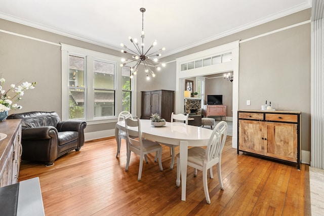 121 N Woodrow St, Little Rock, AR 72205 - dining area featuring a chandelier, ornamental molding, light wood-style floors, and baseboards