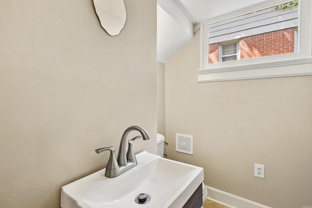 121 N Woodrow St, Little Rock, AR 72205 - bathroom featuring a sink, baseboards, and vaulted ceiling