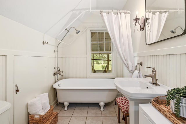 121 N Woodrow St, Little Rock, AR 72205 - full bathroom with toilet, tile patterned floors, a soaking tub, a wainscoted wall, and vaulted ceiling