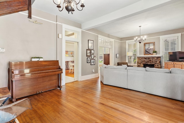 121 N Woodrow St, Little Rock, AR 72205 - living area with a chandelier, beam ceiling, light wood-style floors, a fireplace, and baseboards