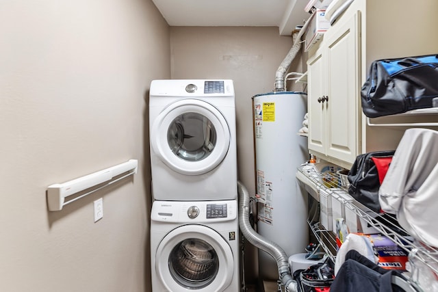 121 N Woodrow St, Little Rock, AR 72205 - laundry area with cabinet space, stacked washer and clothes dryer, and water heater