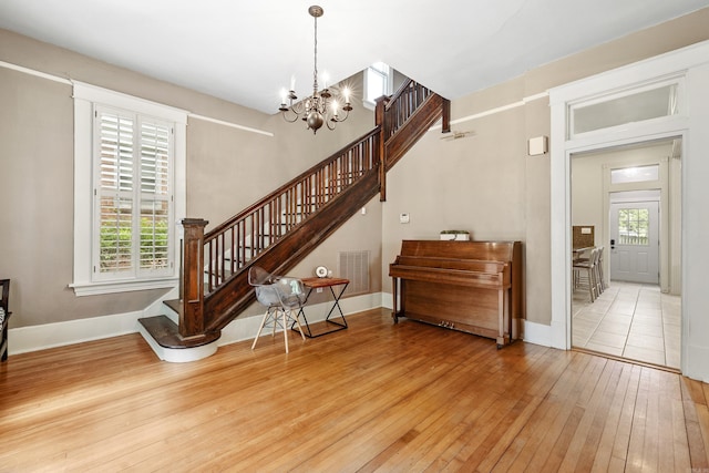121 N Woodrow St, Little Rock, AR 72205 - entryway featuring stairway, hardwood / wood-style flooring, a chandelier, and baseboards