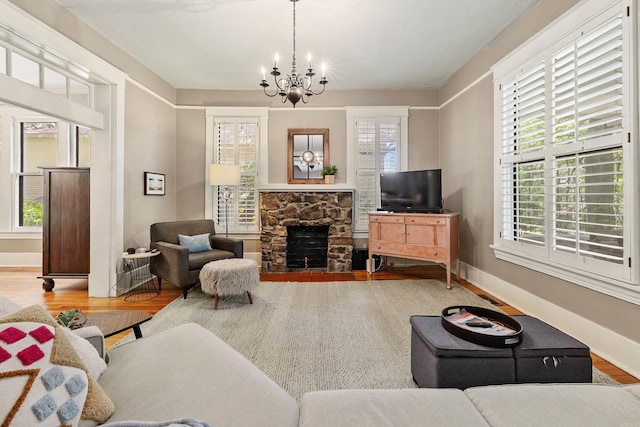 121 N Woodrow St, Little Rock, AR 72205 - living room with wood finished floors, a chandelier, a fireplace, and baseboards