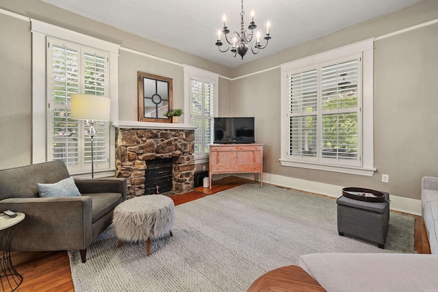 121 N Woodrow St, Little Rock, AR 72205 - living room with a chandelier, wood finished floors, a fireplace, and baseboards