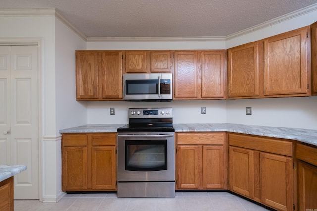 1505 Cherry Brook Dr, Little Rock, AR 72211 - kitchen with appliances with stainless steel finishes, ornamental molding, brown cabinets, light tile patterned flooring, and a textured ceiling