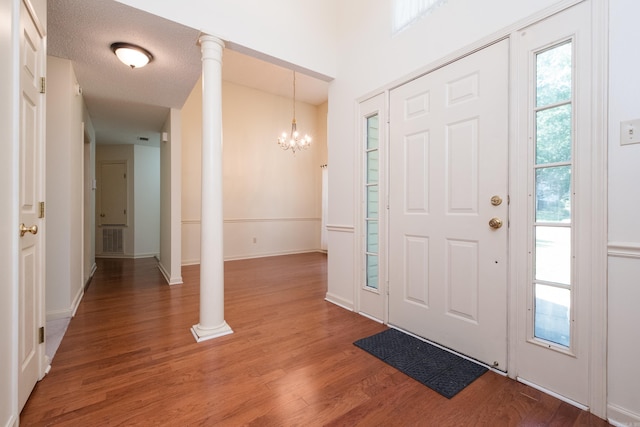 1505 Cherry Brook Dr, Little Rock, AR 72211 - entrance foyer featuring a chandelier, light wood finished floors, ornate columns, and baseboards