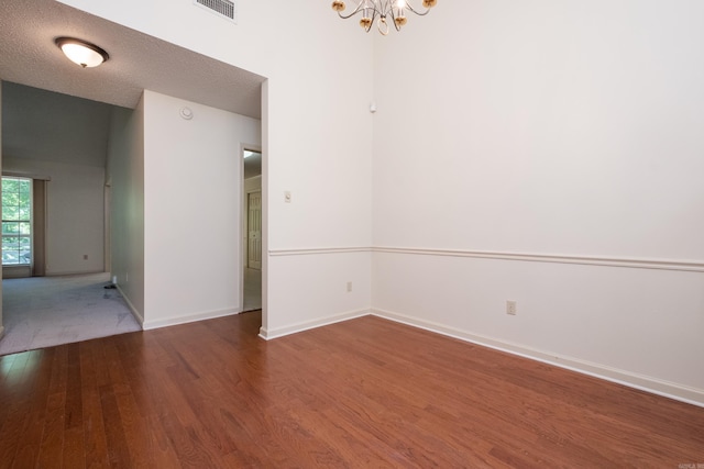 1505 Cherry Brook Dr, Little Rock, AR 72211 - unfurnished room with wood finished floors, a chandelier, baseboards, and a textured ceiling