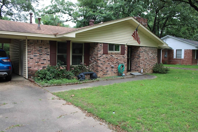 view of home's exterior with brick siding, a chimney, a yard, driveway, and a carport