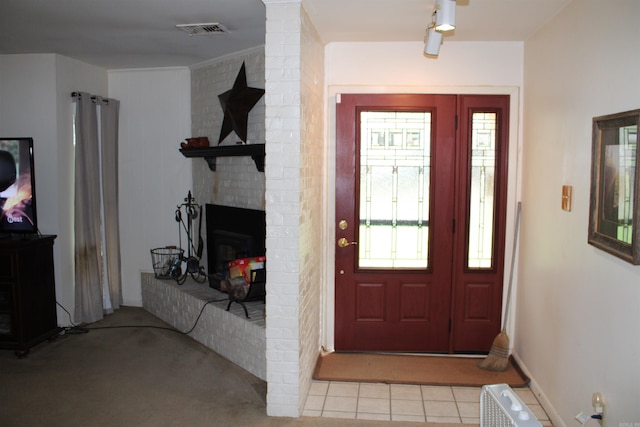 foyer featuring light colored carpet, light tile patterned flooring, and baseboards
