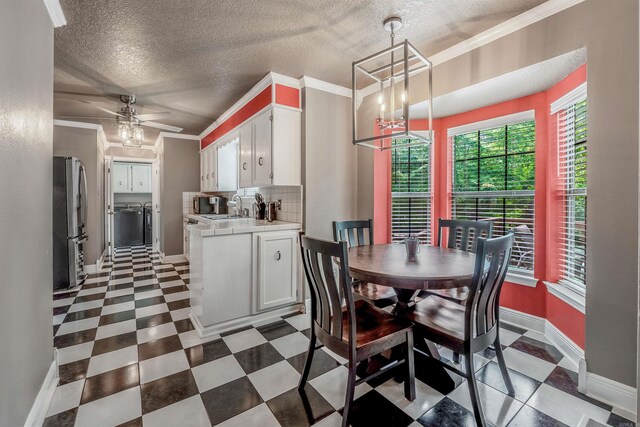 77 Stoneledge Dr, Maumelle, AR 72113 - dining room featuring washing machine and dryer, baseboards, tile patterned floors, a ceiling fan, and a chandelier