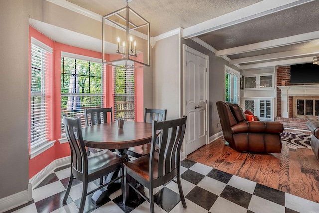 77 Stoneledge Dr, Maumelle, AR 72113 - dining area with baseboards, a chandelier, a textured ceiling, tile patterned floors, and beam ceiling
