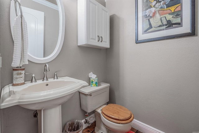 77 Stoneledge Dr, Maumelle, AR 72113 - half bathroom featuring toilet, baseboards, and a sink