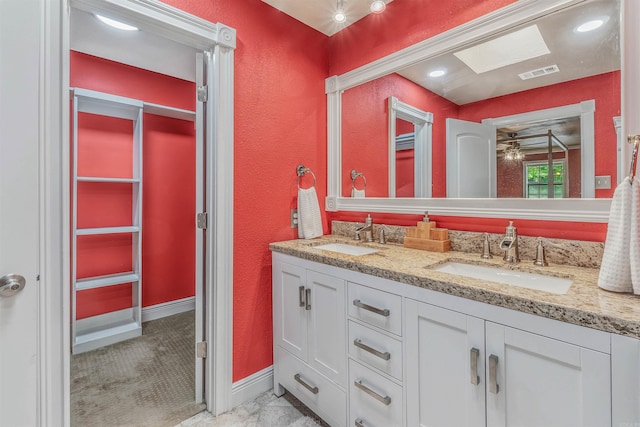 77 Stoneledge Dr, Maumelle, AR 72113 - full bathroom featuring double vanity, a textured wall, and baseboards