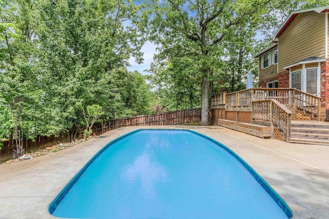 77 Stoneledge Dr, Maumelle, AR 72113 - view of swimming pool with a fenced backyard, a patio area, view of scattered trees, and a deck