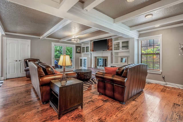 77 Stoneledge Dr, Maumelle, AR 72113 - living area featuring a textured ceiling, baseboards, wood finished floors, beam ceiling, and a fireplace