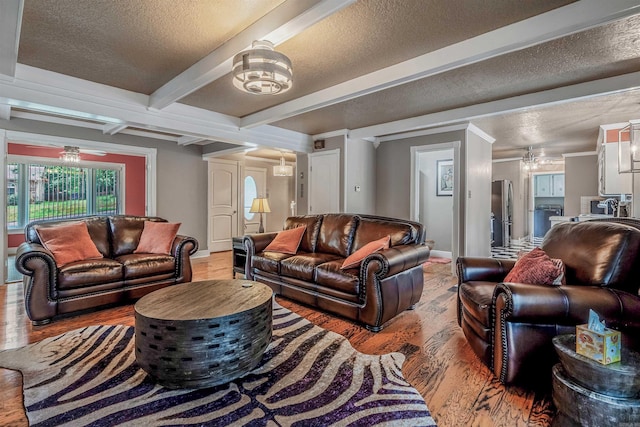 77 Stoneledge Dr, Maumelle, AR 72113 - living area featuring light wood-style floors, a chandelier, baseboards, a textured ceiling, and beamed ceiling