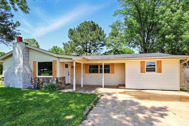 13512 Peters Rd, Cabot, AR 72023 - view of front of house with a chimney, a front yard, and covered porch