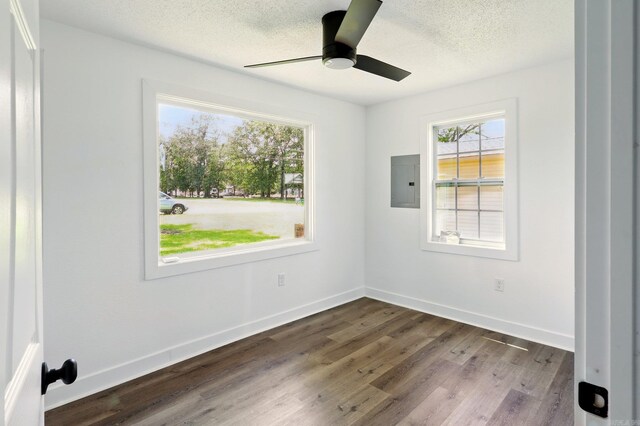 13512 Peters Rd, Cabot, AR 72023 - spare room featuring plenty of natural light, electric panel, dark wood-style floors, a ceiling fan, and a textured ceiling