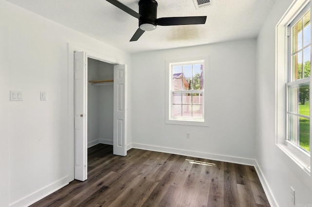 13512 Peters Rd, Cabot, AR 72023 - unfurnished bedroom with multiple windows, dark wood-style floors, and baseboards