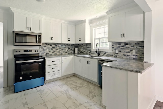 13512 Peters Rd, Cabot, AR 72023 - kitchen with stainless steel microwave, electric range, light marble finish floors, a sink, and white cabinets