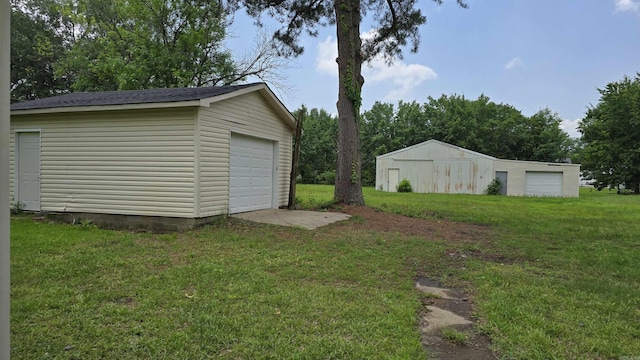 13512 Peters Rd, Cabot, AR 72023 - view of green lawn with an outbuilding and a garage