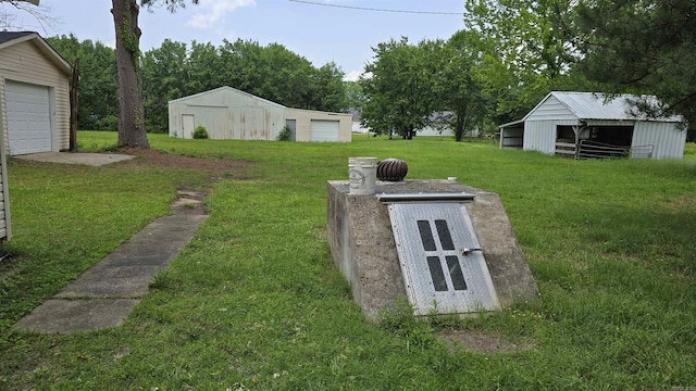 13512 Peters Rd, Cabot, AR 72023 - view of storm shelter featuring a yard, an outdoor structure, and a pole building