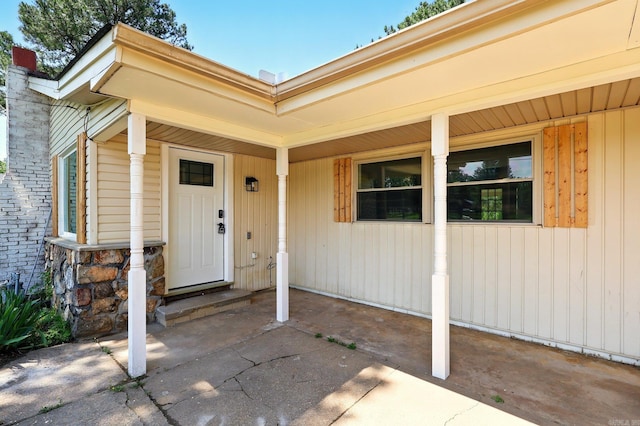13512 Peters Rd, Cabot, AR 72023 - doorway to property featuring covered porch, a chimney, and stone siding