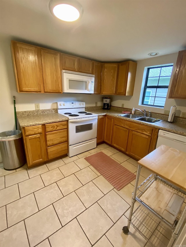 816 N Polk, Little Rock, AR 72205 - kitchen featuring white appliances, a sink, light tile patterned floors, brown cabinetry, and light countertops