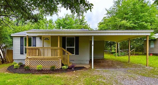 1307 Aplin Ave, Perryville, AR 72126 - view of front of property featuring dirt driveway, a front yard, an attached carport, covered porch, and crawl space