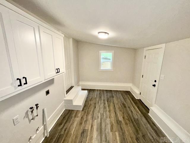 1307 Aplin Ave, Perryville, AR 72126 - laundry room with electric dryer hookup, cabinet space, dark wood-style floors, and baseboards