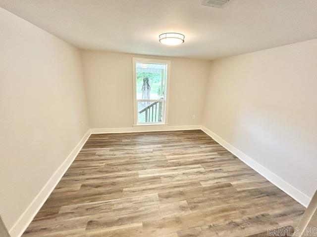 1307 Aplin Ave, Perryville, AR 72126 - unfurnished room featuring baseboards and wood finished floors