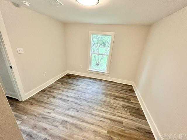 1307 Aplin Ave, Perryville, AR 72126 - unfurnished room with dark wood finished floors, a smoke detector, and baseboards